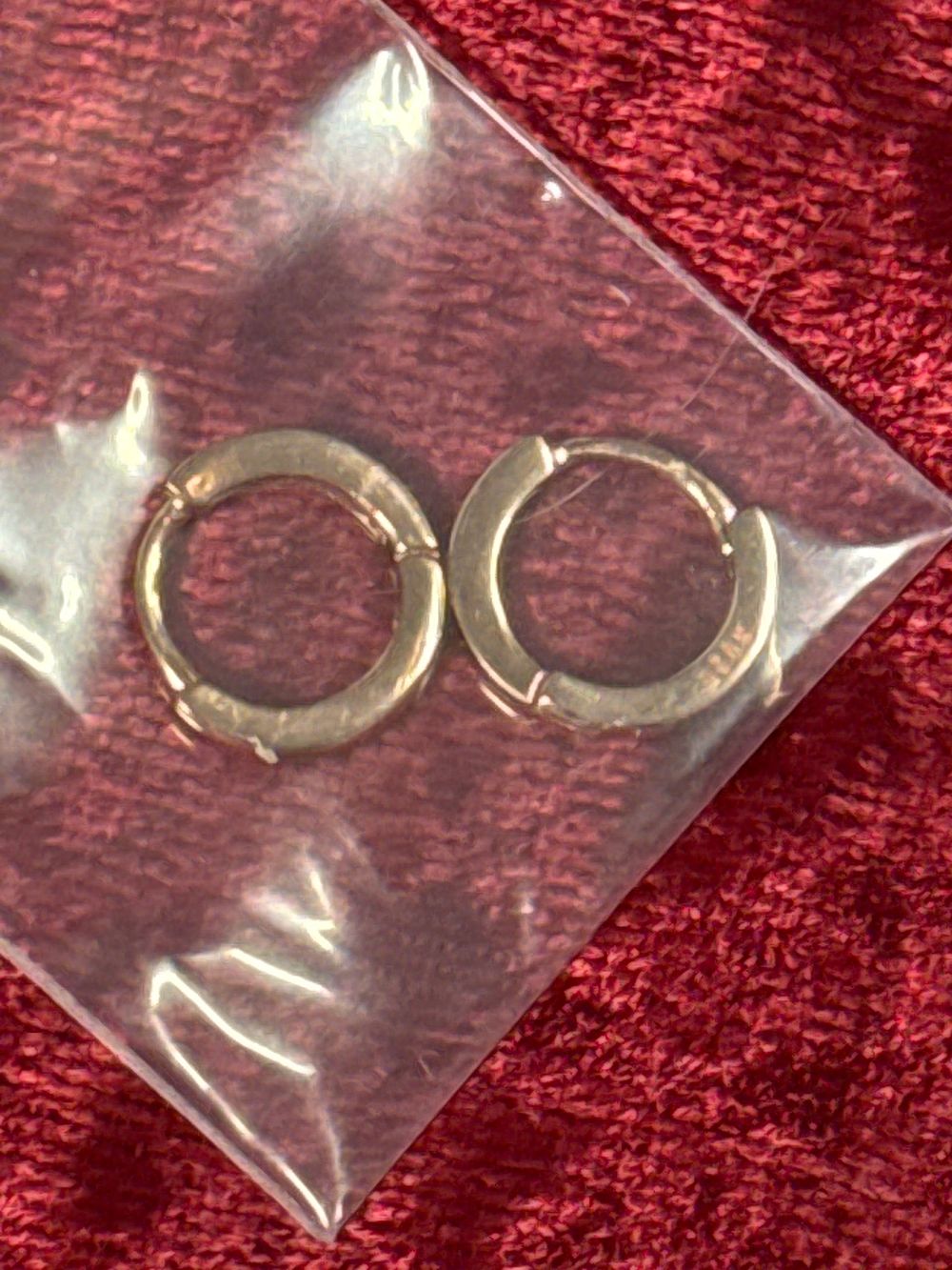 Lot 86: A pair of small gold plated sterling silver huggie earrings