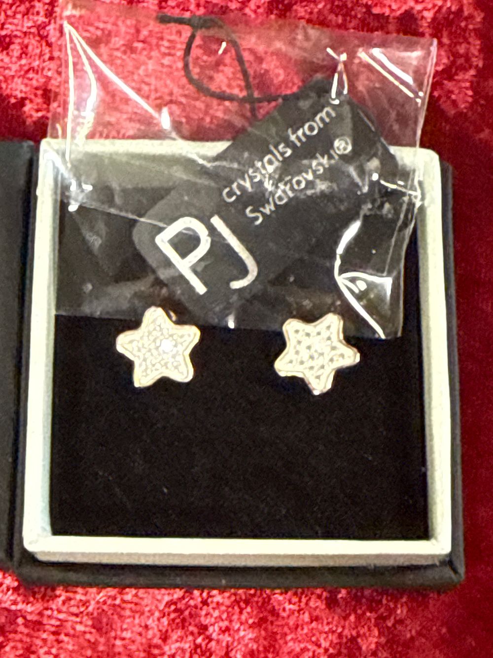 Lot 88: A pair of star motif stud earrings set with Swarovski crystals