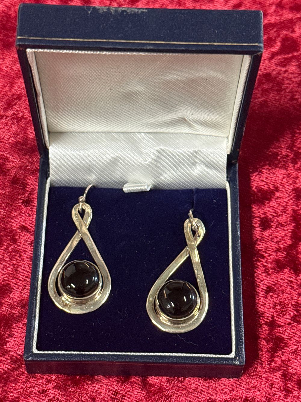 Lot 95: A pair of sterling silver and black cabochon drop earrings