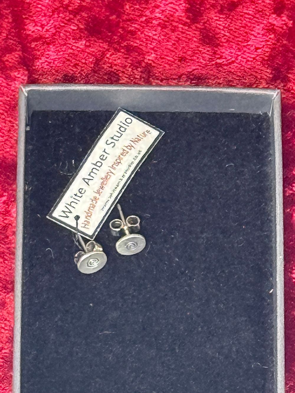 Lot 111: A Pair of Sterling Silver Stud Earrings by White Amber Studio