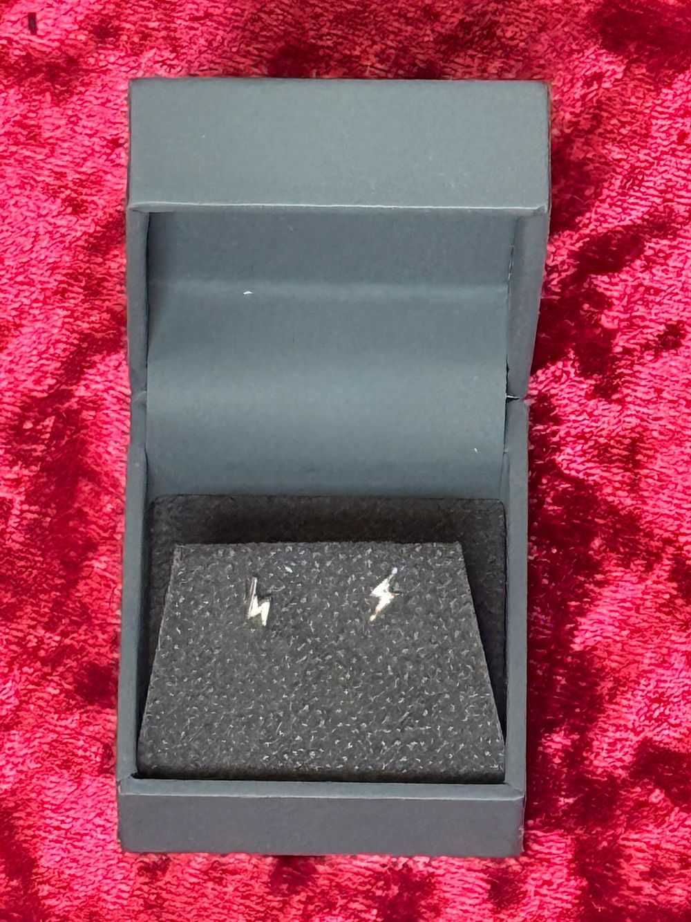 Lot 115: A pair of sterling silver lightning bolt stud earrings