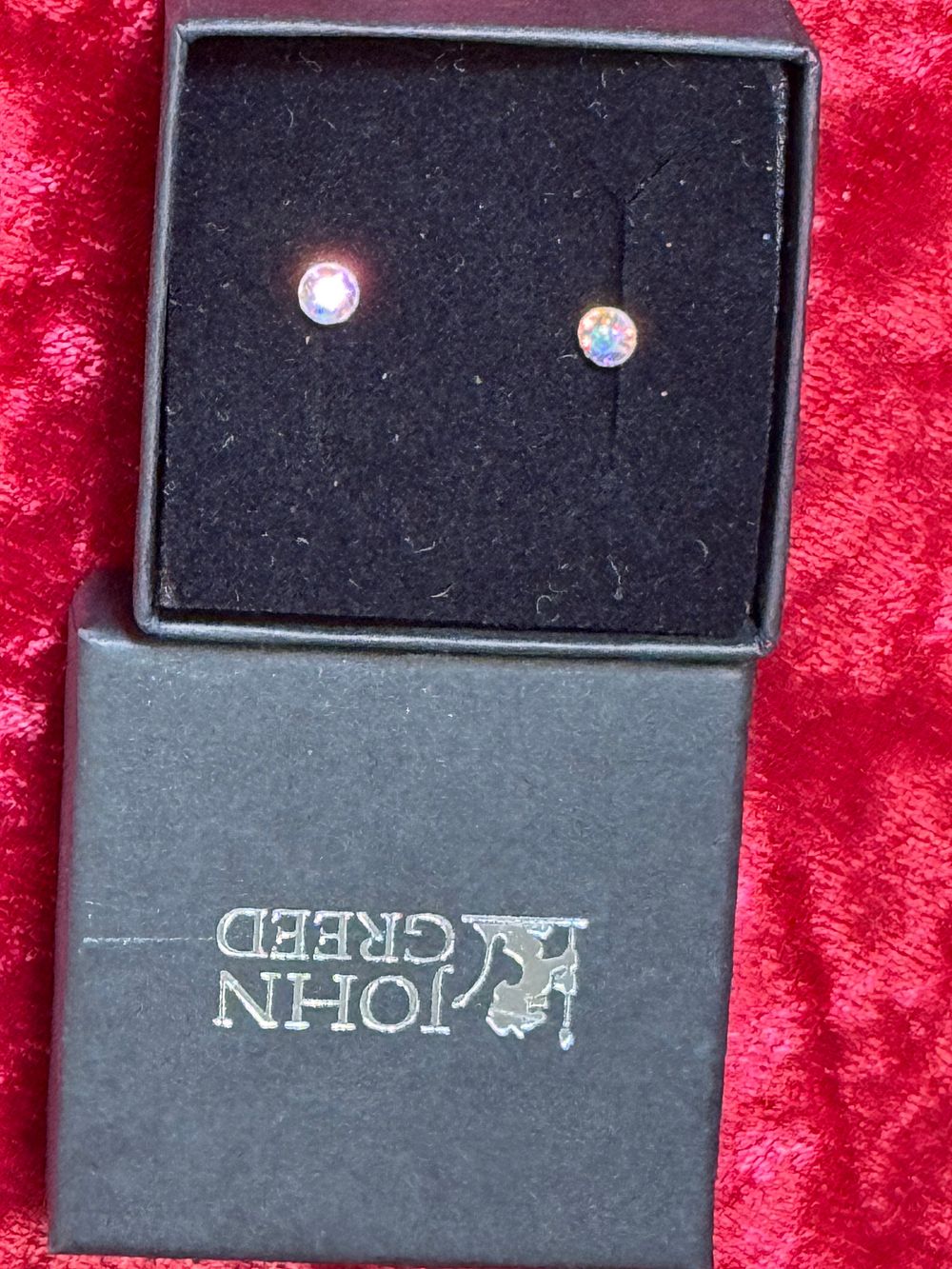 Lot 120: A pair of John Greed iridescent stone stud earrings