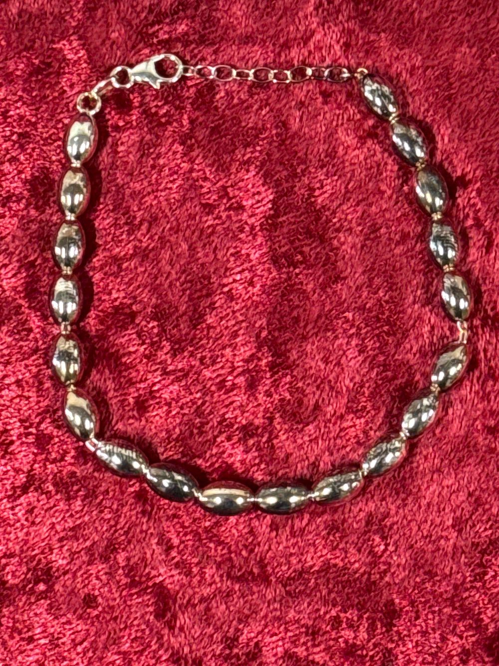 Lot 208: A sterling silver rice bead bracelet with lobster clasp