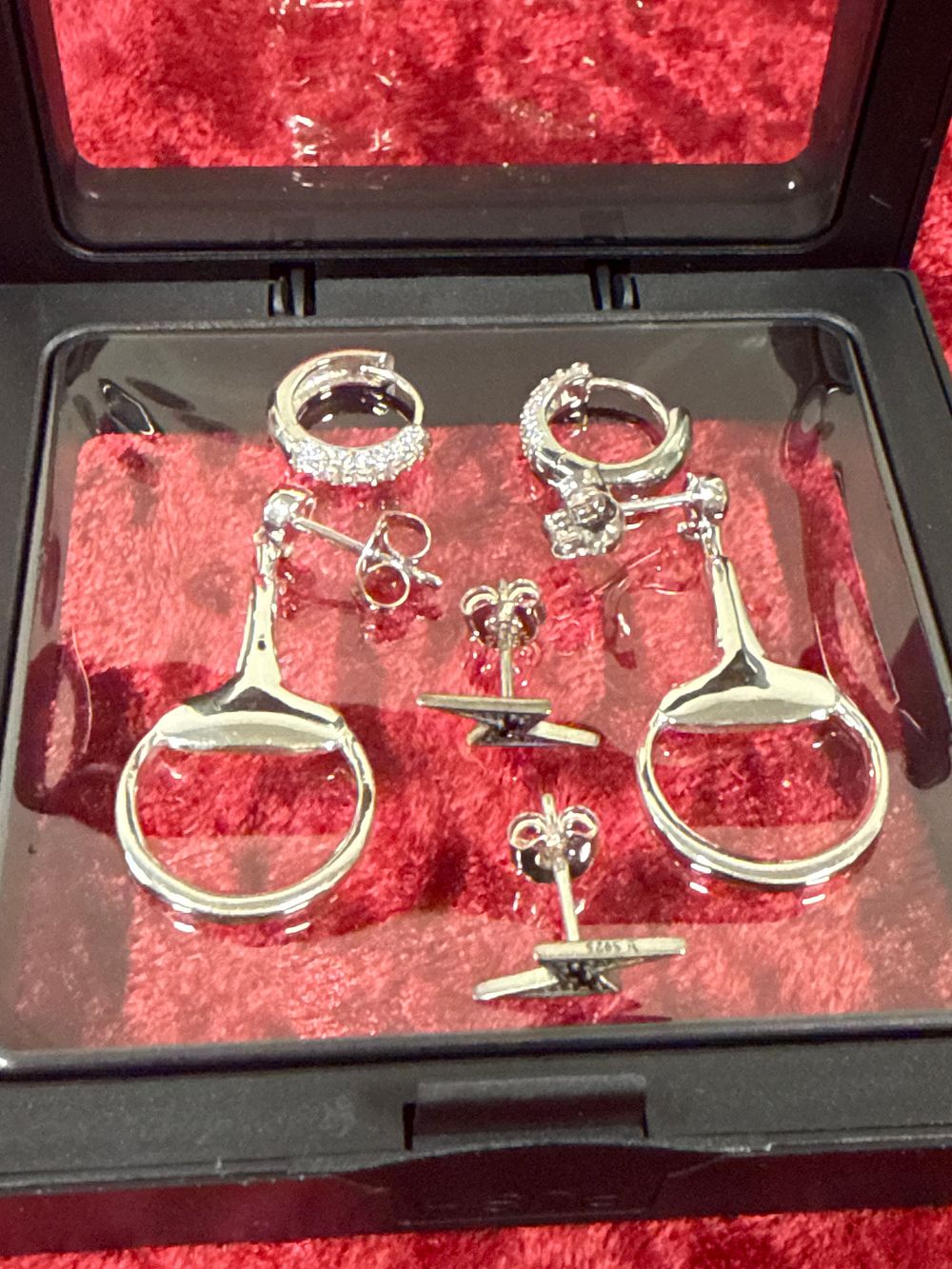 Lot 213: A Collection of Sterling Silver Earrings in a Display Case