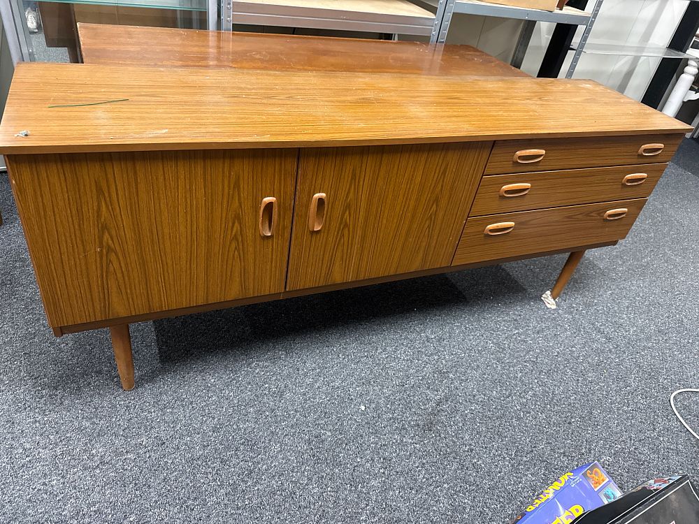 Lot 231: Mid-century teak-effect sideboard with recessed wooden handles