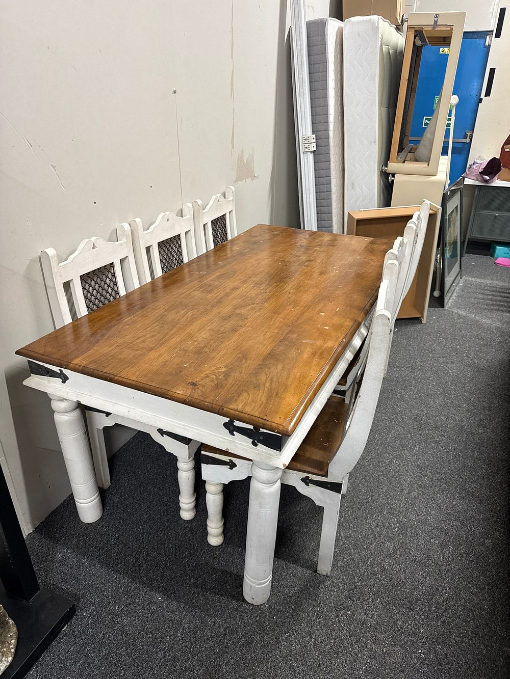Lot 237: A Rustic Two-Tone Jali Wood Dining Table and Set of Chairs