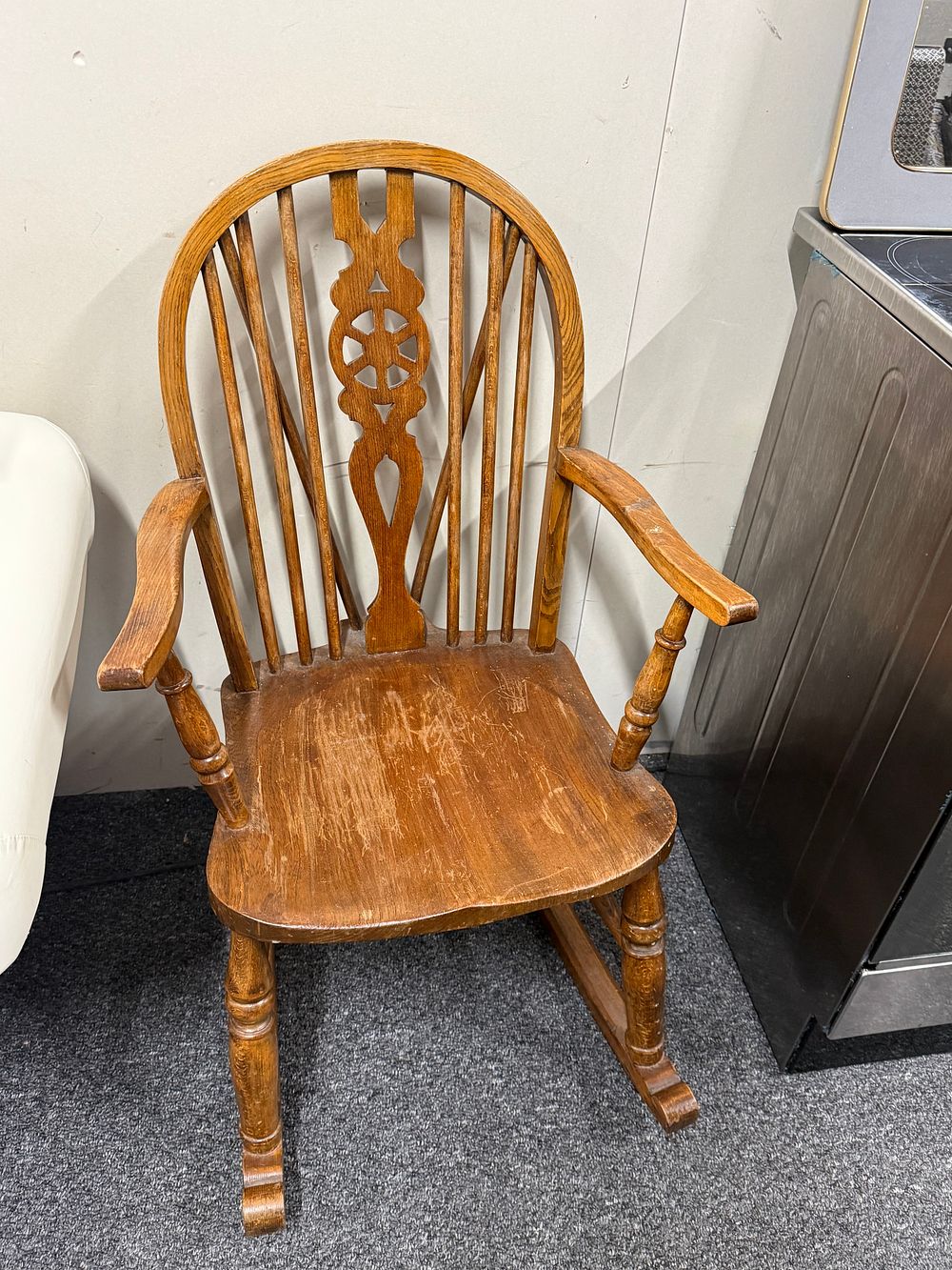 Lot 245: Stained wood wheelback Windsor style rocking armchair