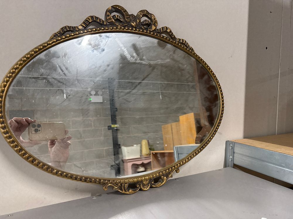 Lot 252: Vintage gilt-framed oval wall mirror with ribbon bow crest