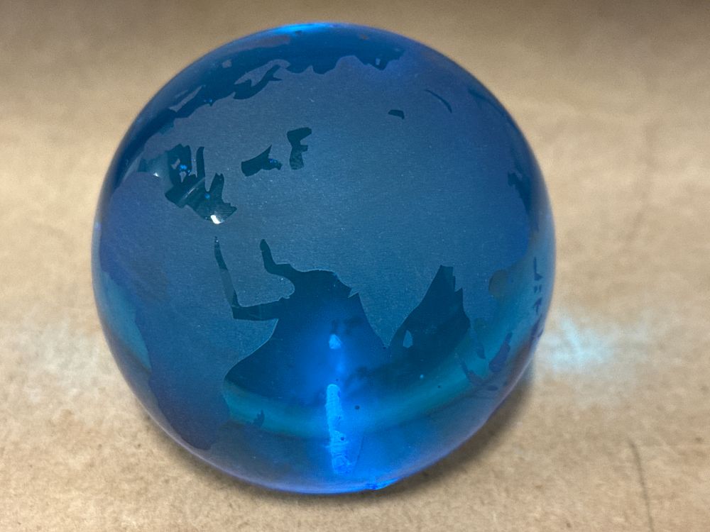 Lot 255: A Frosted Blue Glass Terrestrial Globe Paperweight