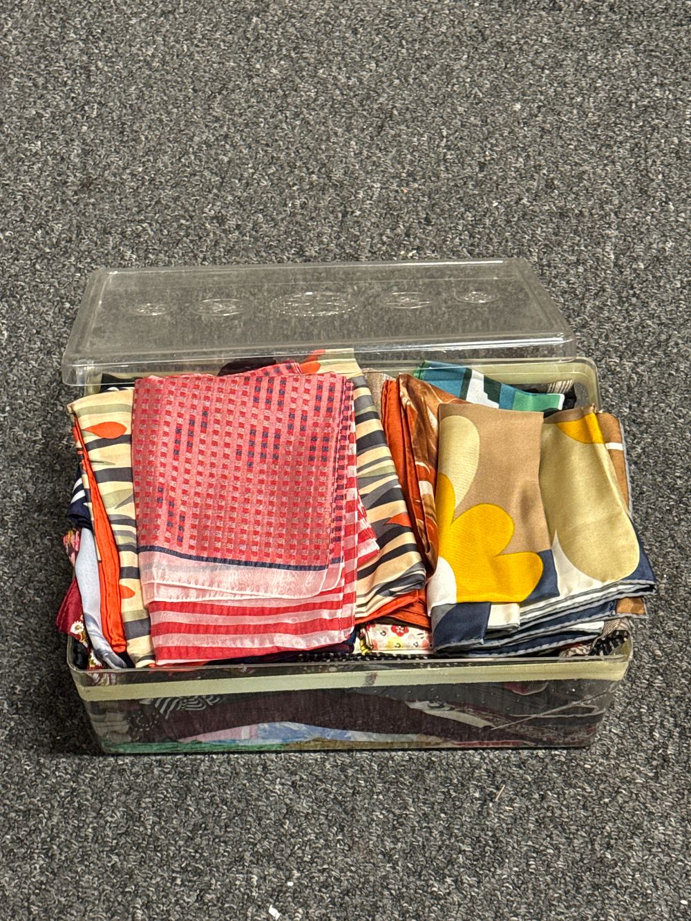 Lot 282: A collection of assorted patterned scarves in a plastic container