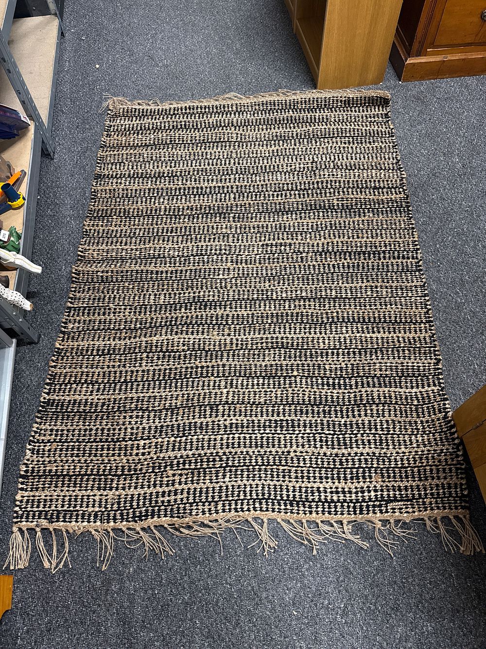 Lot 288: A black and natural woven jute flatweave area rug