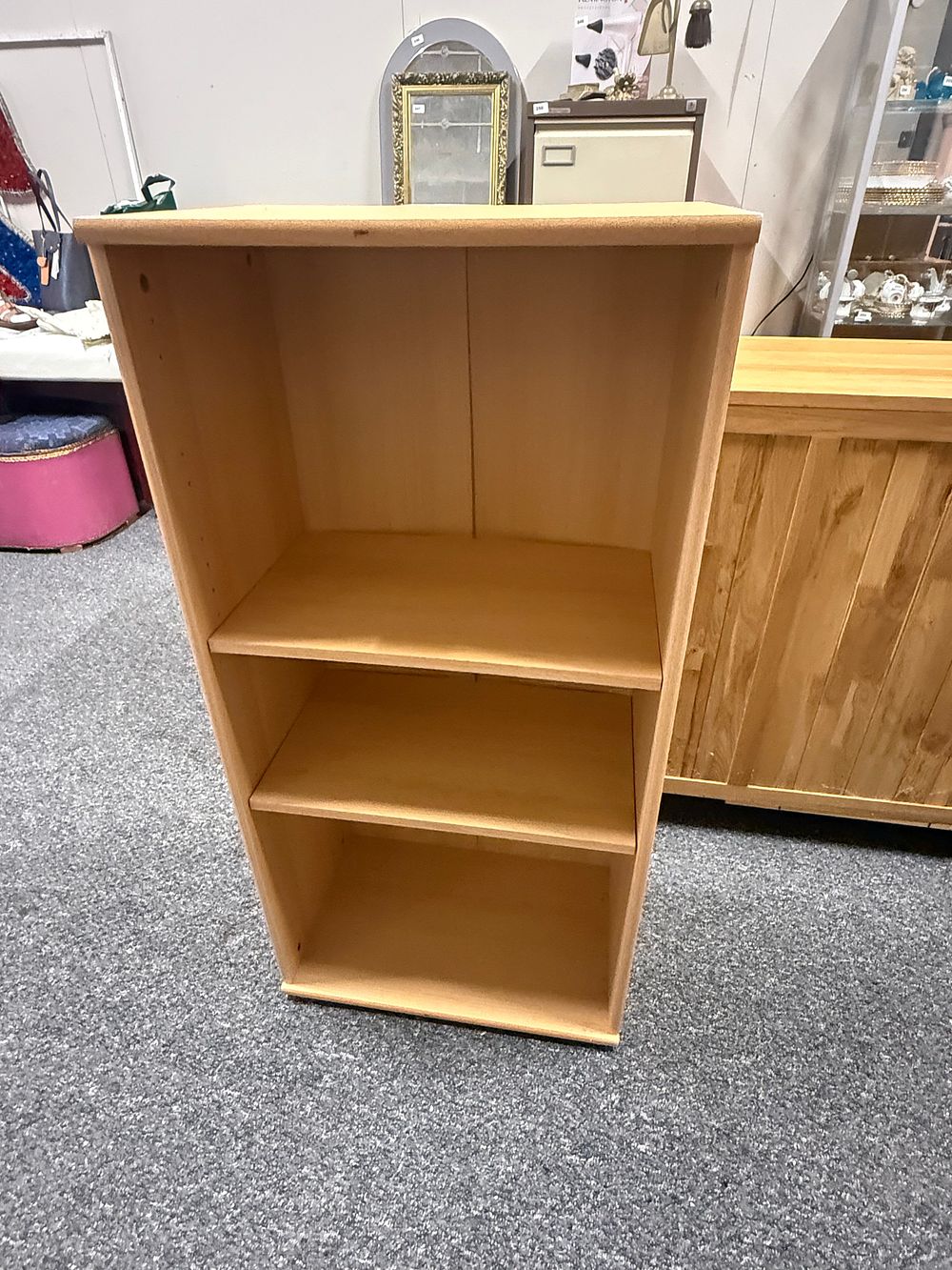 Lot 295: A contemporary three tier light wood effect upright bookcase