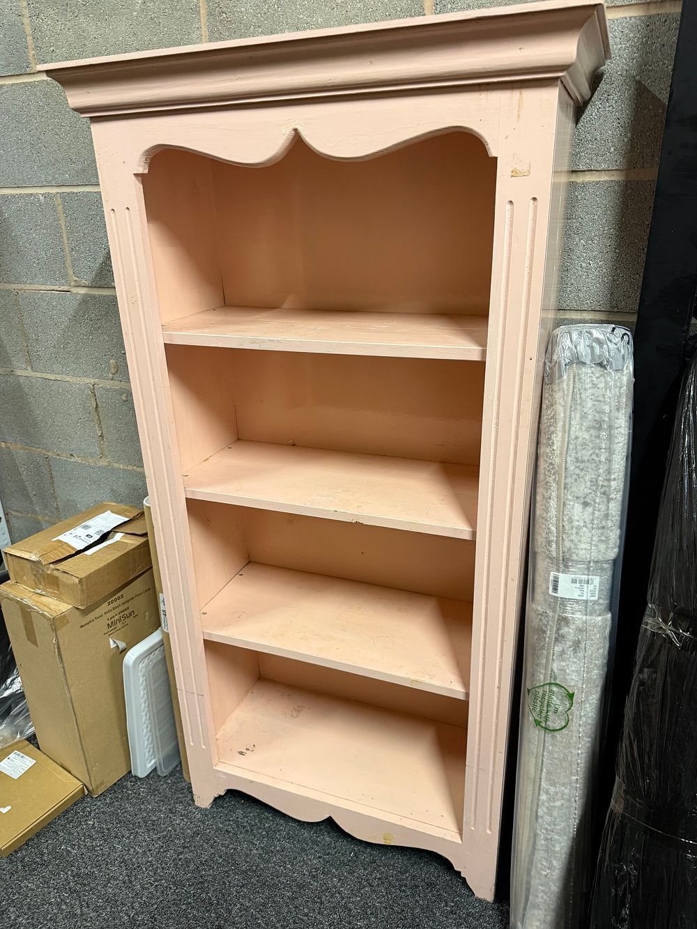 Lot 297: A free standing wooden open display shelf in dusty rose