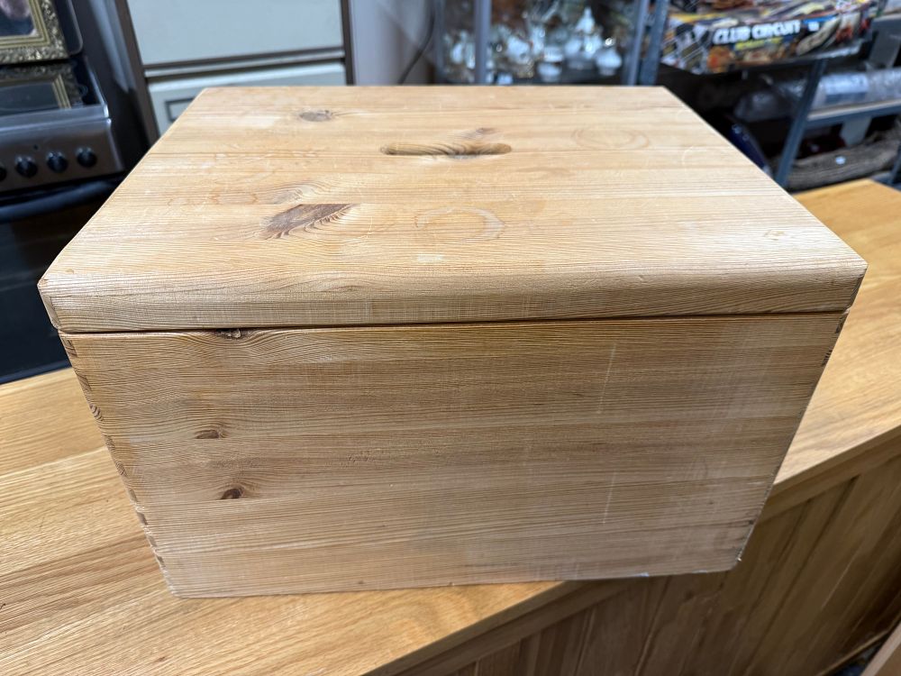 Lot 298: A large pine lidded storage chest with integrated handles