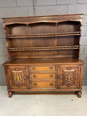 A Jacobean Revival Carved Oak Dresser, Late 19th/Early 20th Century. A two-part oak dresser with 