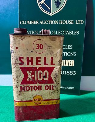 A Vintage Shell X-100 Motor Oil Can, constructed from tin or steel, indicative of a 