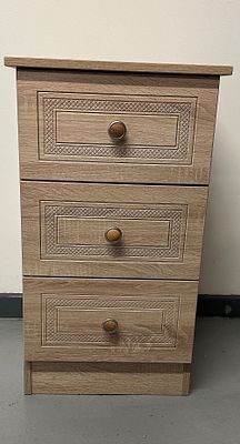 A Contemporary Wood-Effect Laminate Three-Drawer Nightstand. A contemporary three-drawer chest 