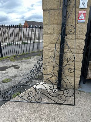 A Pair of Early 20th Century Wrought Iron Decorative Scrollwork Panels. A pair of black-finished 