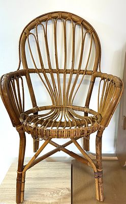 A Mid-Century Rattan Armchair. A mid-20th century armchair constructed from bent rattan and 