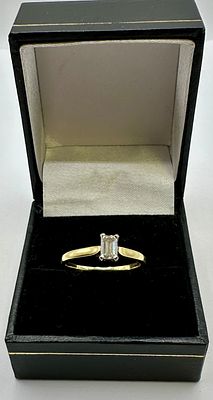 An 18 Carat Gold and Emerald Cut Diamond Solitaire Ring