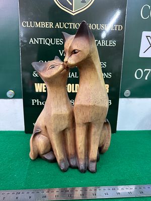 A Pair of Mid-Century Modern Carved Wood Cats. A Mid-Century Modern carved wooden figurine 
