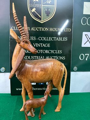 Hand-Carved Wooden Antelope Mother and Fawn Sculpture. A hand-carved wooden sculpture depicting 