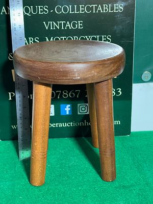 Wooden Milking Stool,. A Milking Stool, Crafted from solid wood with a light to medium-brown 