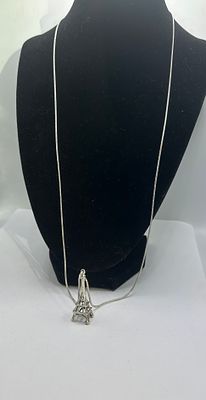 A 925 Silver Eiffel Tower Pendant Necklace. A 925 silver necklace featuring a snake chain and a 