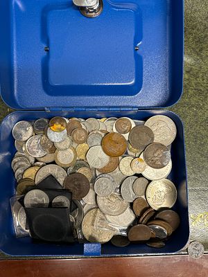 A Collection of Mixed International and British Coins in a Blue Metal Cash Box. A blue textured 