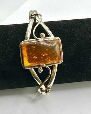 A Baltic Amber and 925 Silver Cuff Bracelet. An open-cuff bracelet crafted from 925 silver 
