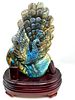 A Carved Labradorite Peacock Sculpture on Wooden Base. A hand-carved labradorite sculpture Image - 1