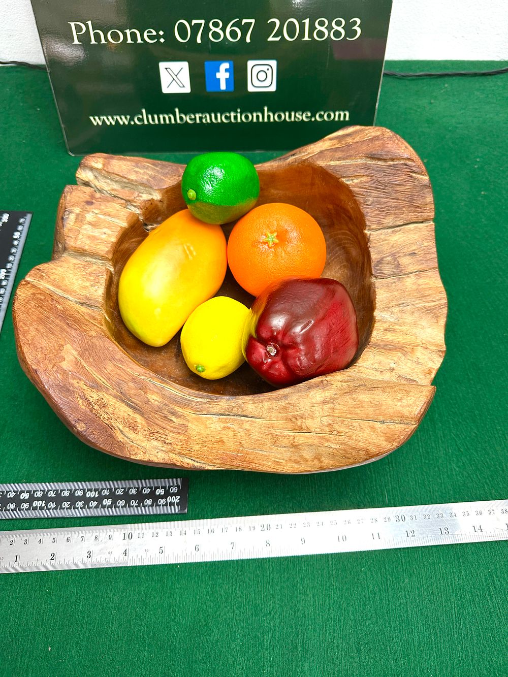 A Hand-Carved Mango Wood Bowl. A hand-carved mango wood bowl featuring an organic, rustic form 