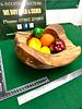 A Hand-Carved Mango Wood Bowl. A hand-carved mango wood bowl featuring an organic, rustic form Image - 1