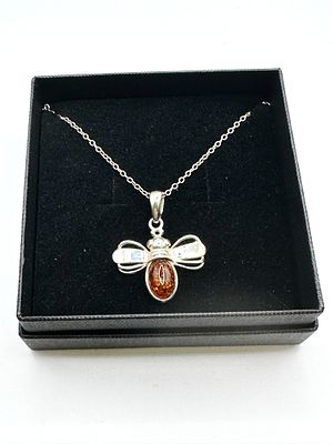 A Baltic Amber and 925 Silver Bee Pendant Necklace. A pendant necklace featuring a stylized bee 