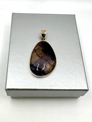 A Sterling Silver and Blue John Fluorite Pendant. A sterling silver pendant featuring a large 