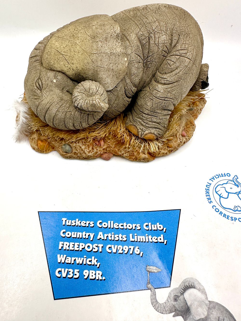 Country Artists Tuskers Elephant Figurine All Curled Up Model 91209. A cast resin collectible 