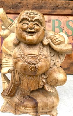 Hand-Carved Wood Laughing Buddha Statue. A hand-carved wood statue depicting the Laughing Buddha 