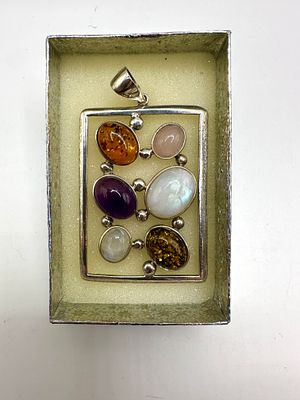 A Modernist Silver-Toned Multi-Gemstone Pendant. A modernist rectangular pendant of open-frame 