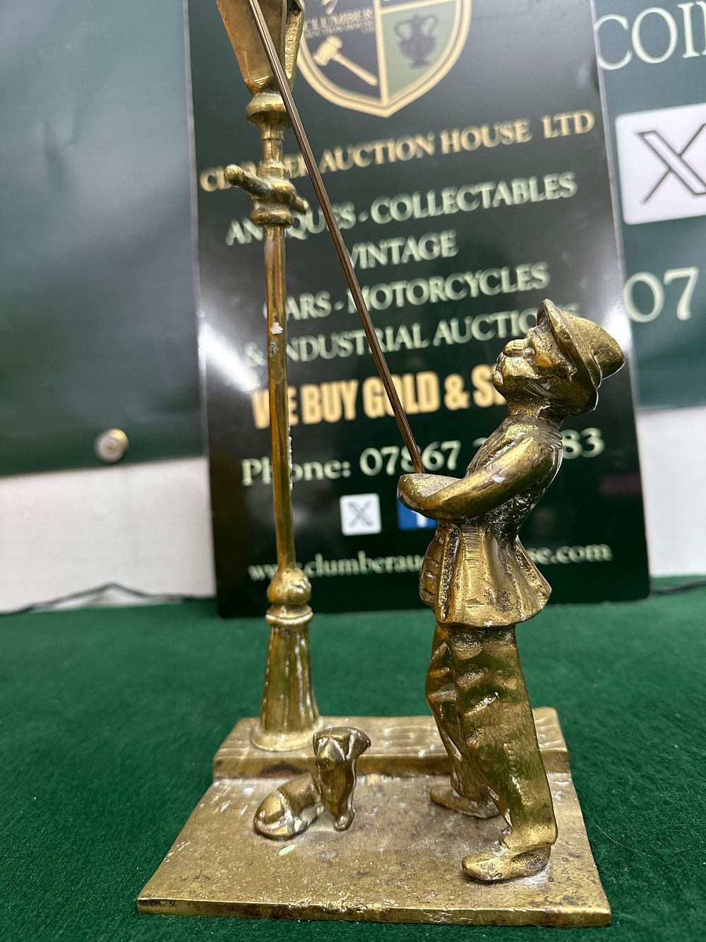 A Cast Brass Figurine of a Lamplighter with a Dog. A cast brass figurine depicting a traditional 