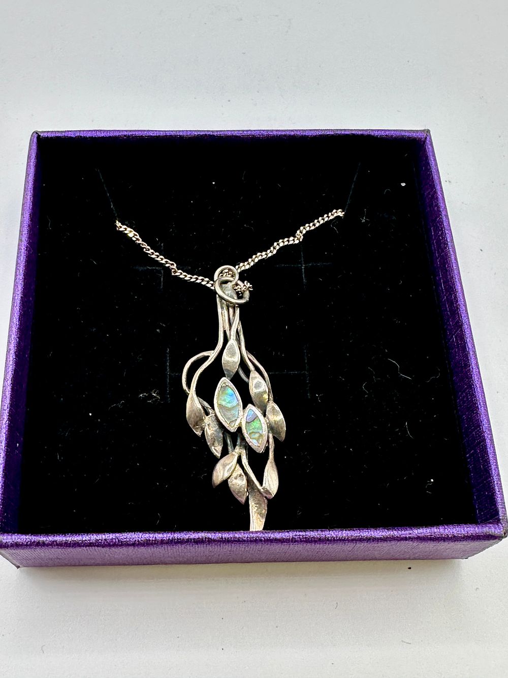 Lot 178: A White Metal Arts and Crafts Style Foliate Pendant Necklace with Iridescent Inlays