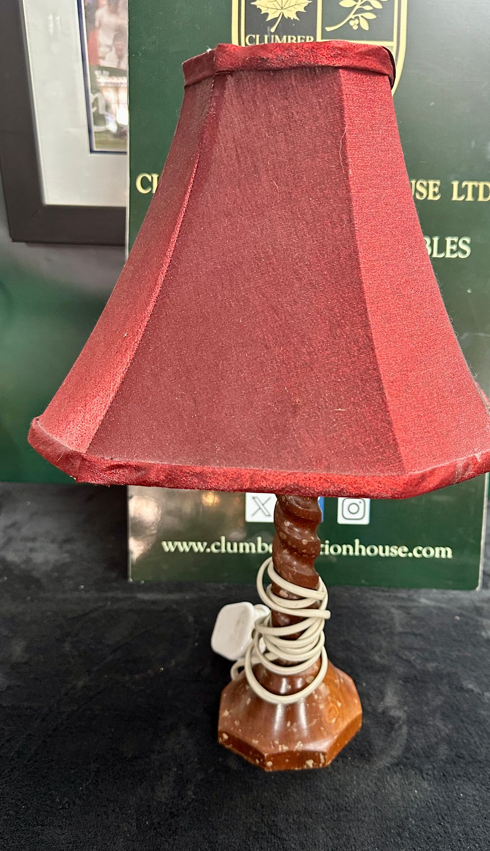Lot 214: A small turned wooden barley-twist table lamp with a hexagonal red fabric shade