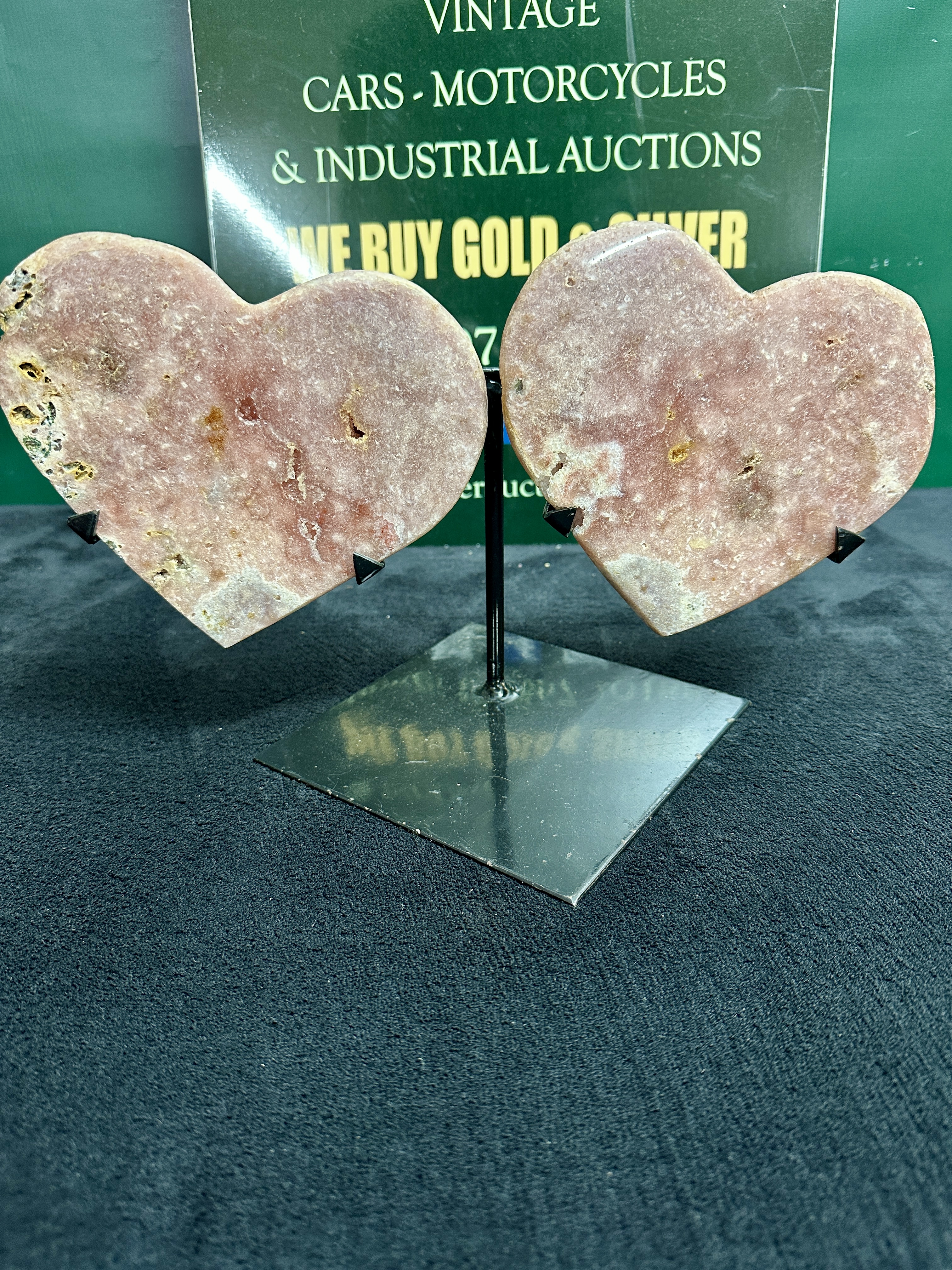 A Pair of Heart-Shaped Pink Amethyst Slabs on a Double Metal Display Stand