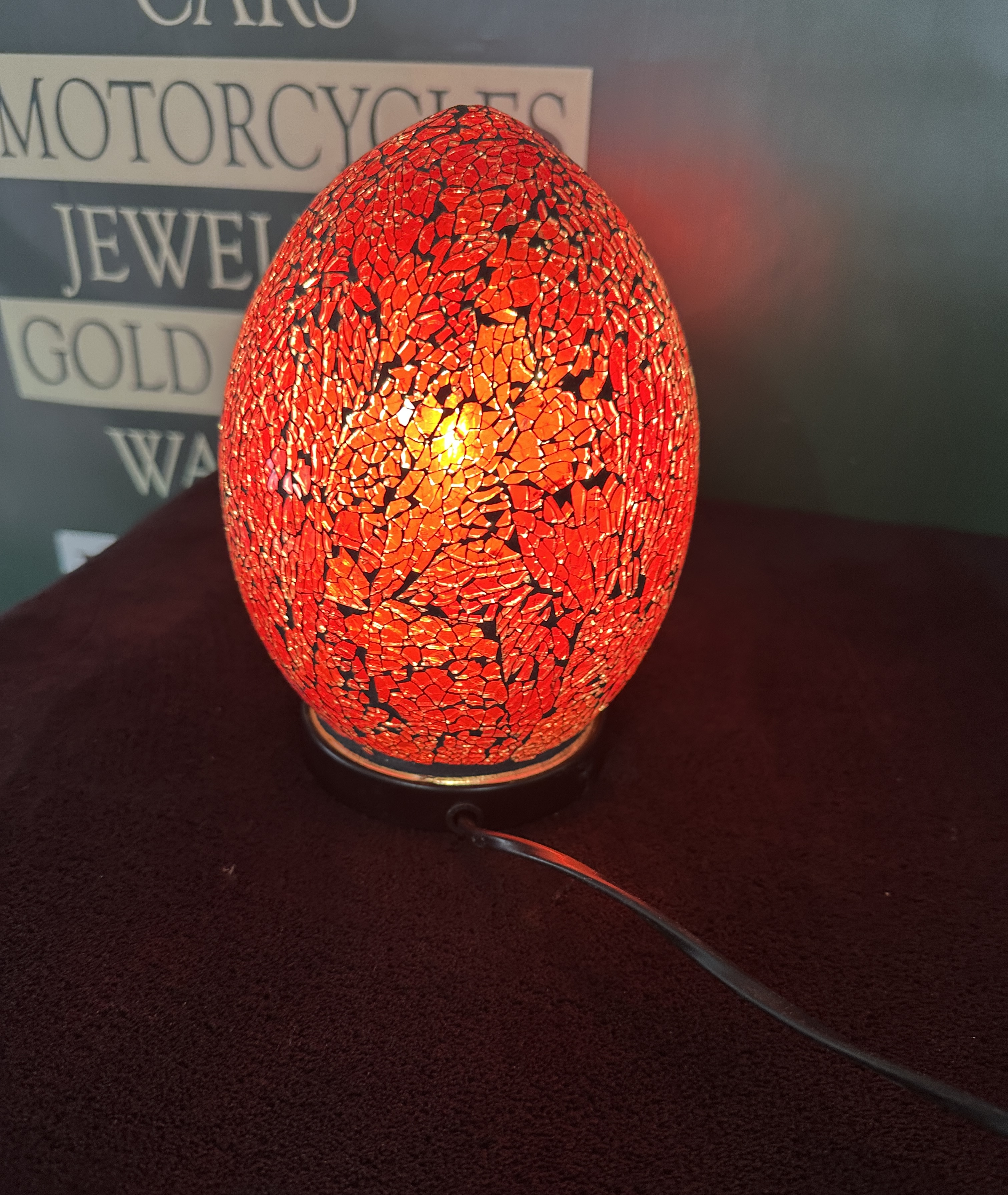 A contemporary red mosaic glass egg table lamp