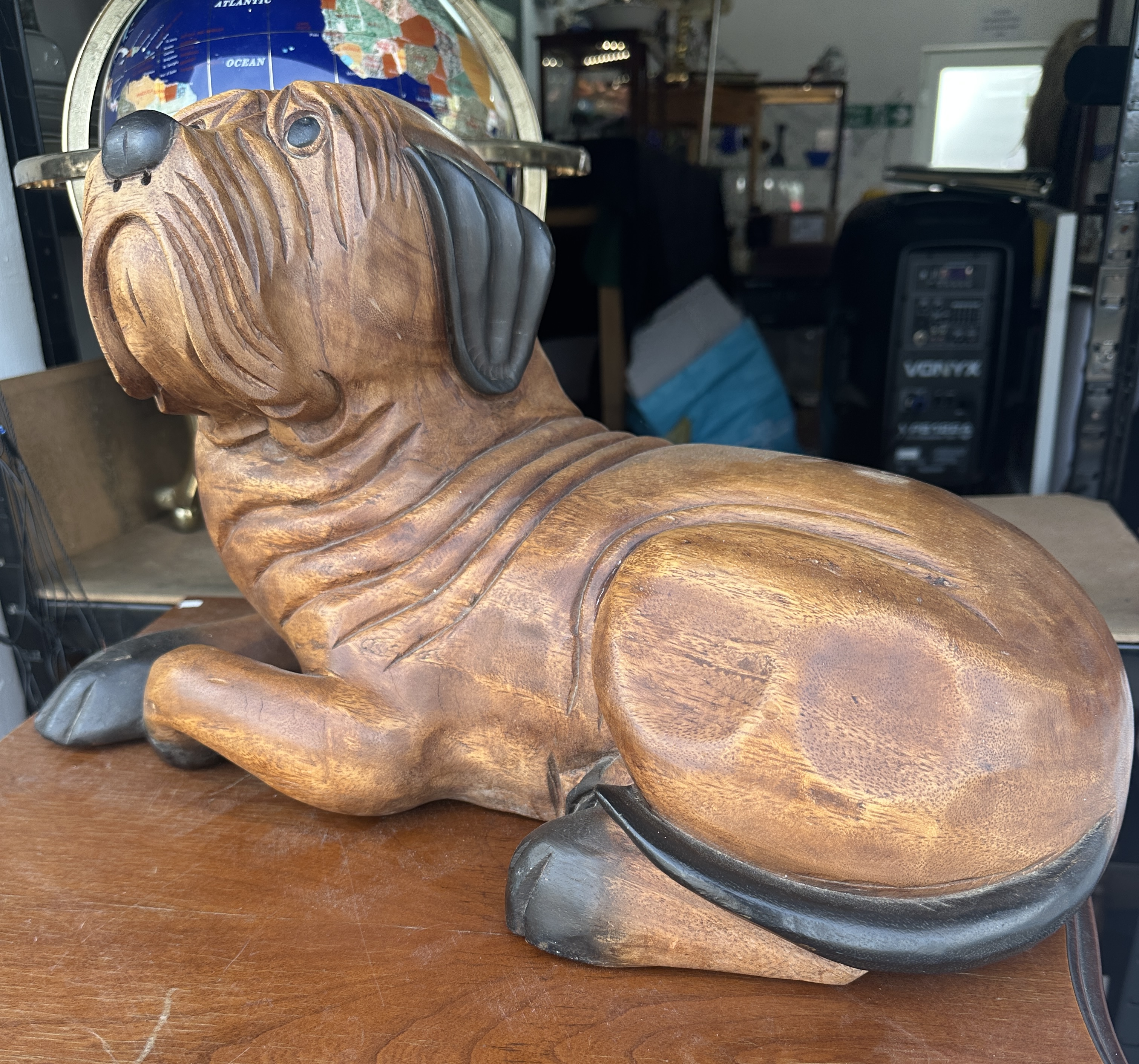 A Large Hand-Carved Wooden Sculpture of a Reclining Bulldog