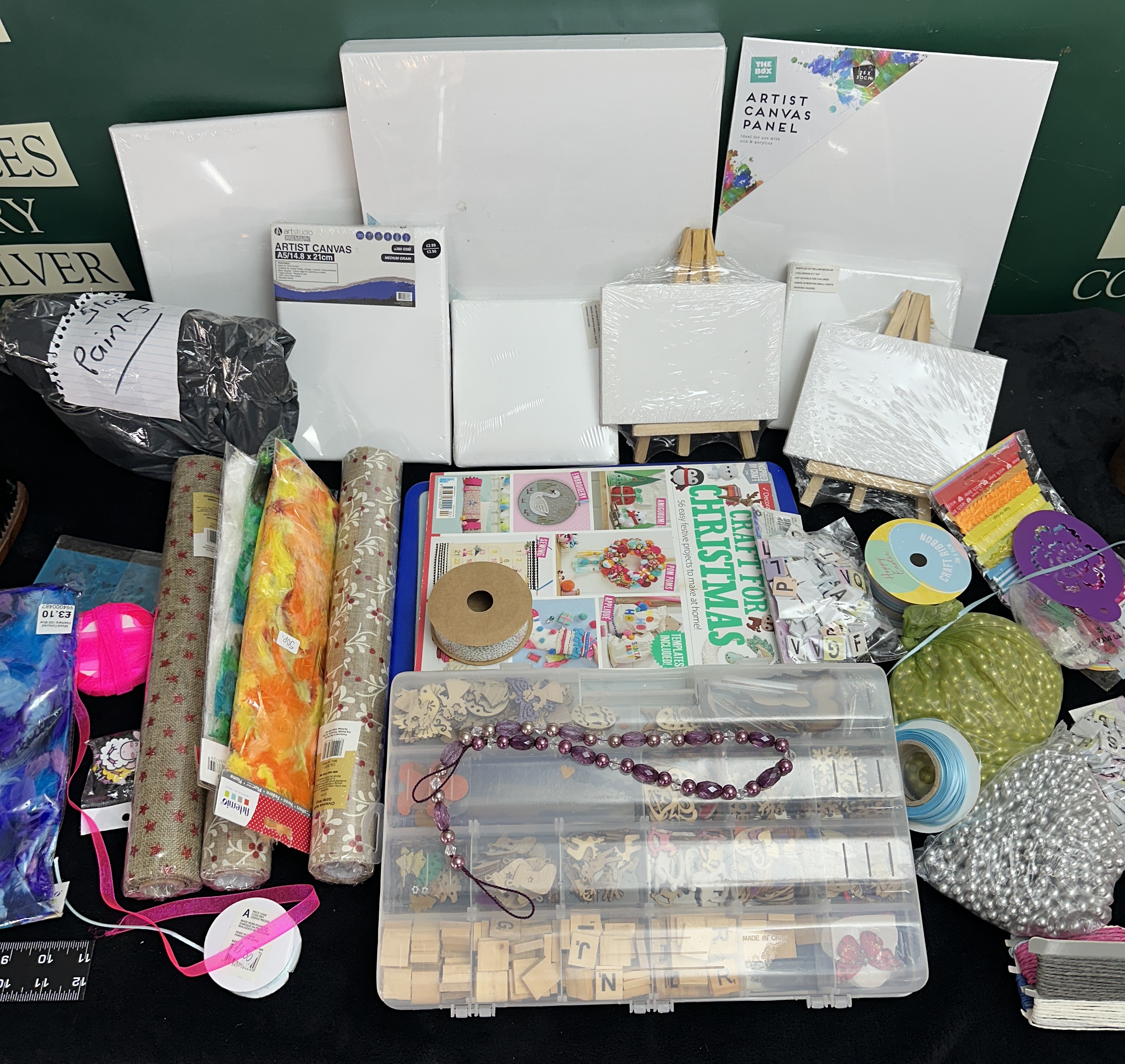 A Collection of Art and Craft Supplies Including Artist Canvases, Decorative Materials, and Craft Components