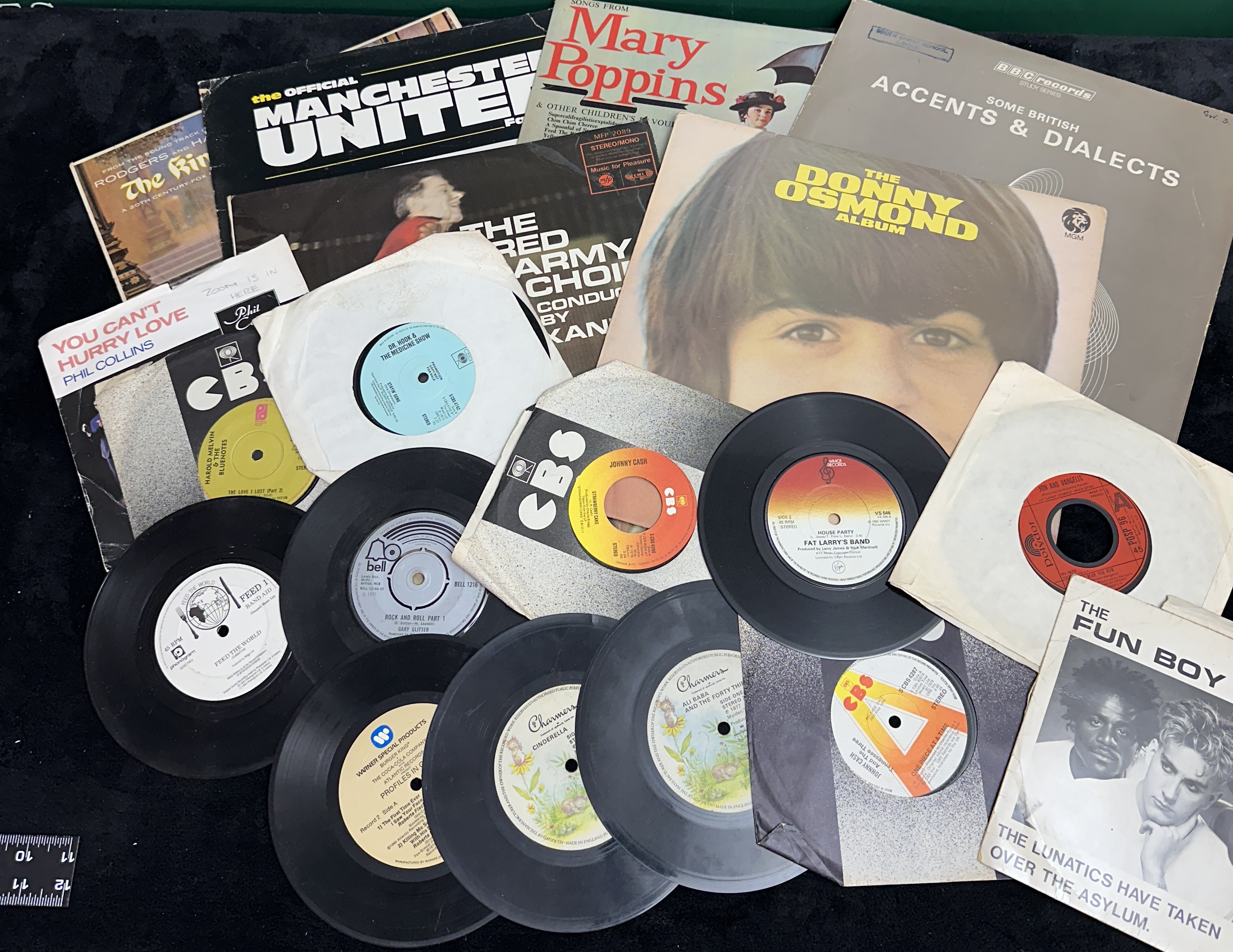 A Collection of Vinyl LPs and 7-inch Singles including The Official Manchester United FC Album and Phil Collins