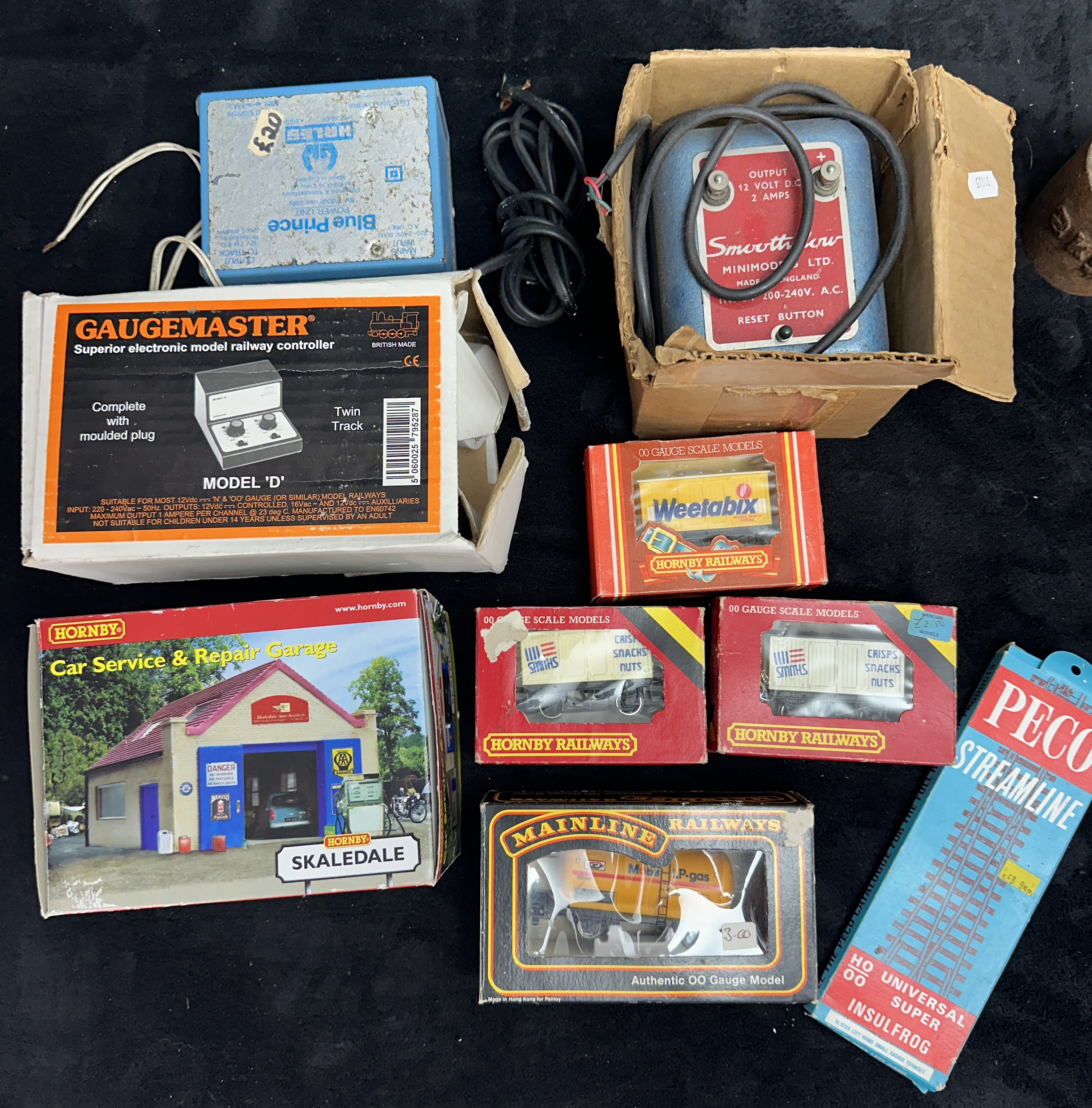 A Collection of OO Gauge Model Railway Controllers, Rolling Stock, and Scenic Accessories