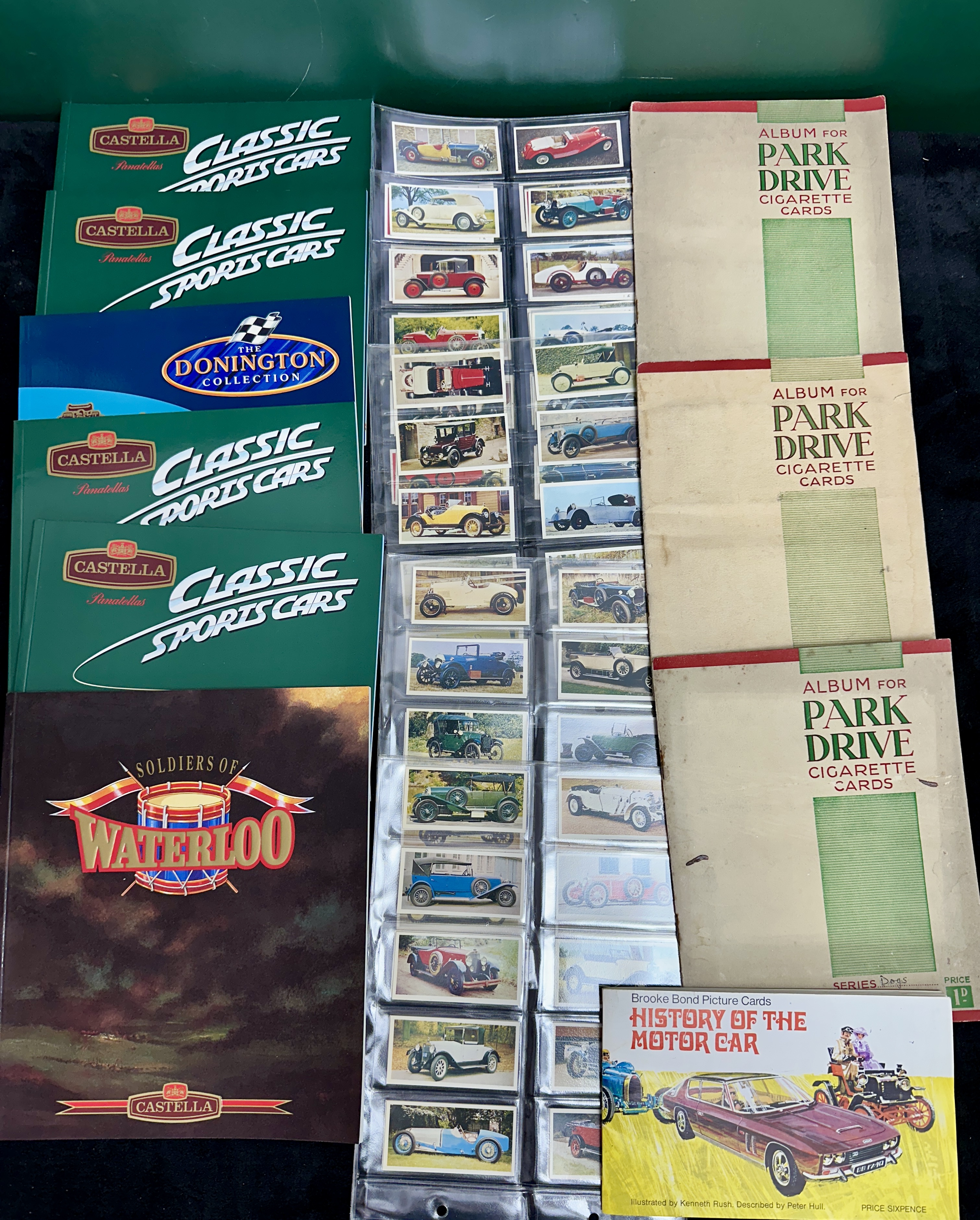 A Collection of Vintage Trade and Cigarette Card Albums and Loose Cards Featuring Automotive and Historical Themes