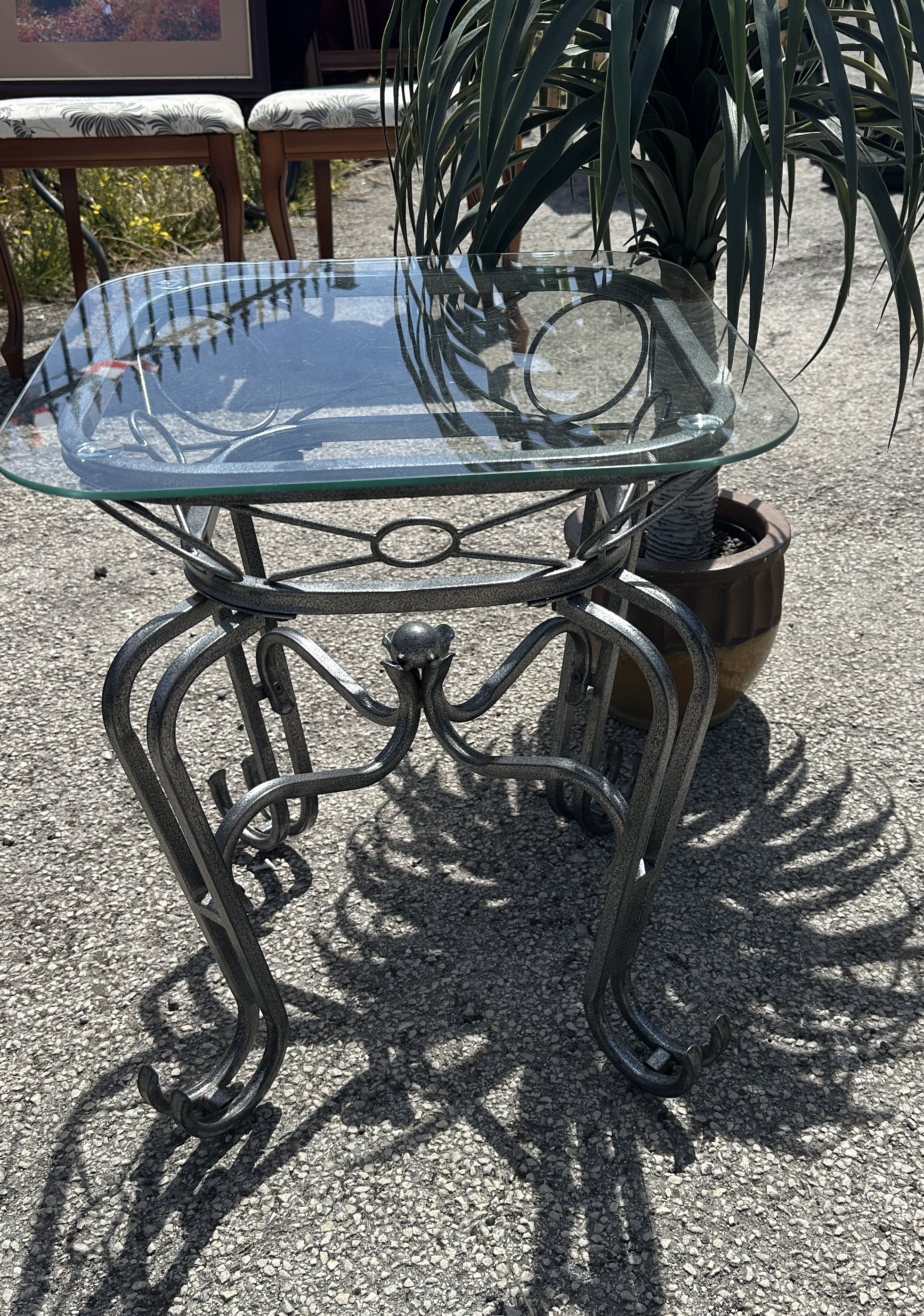 A Contemporary Hammered Metal and Glass Top Side Table