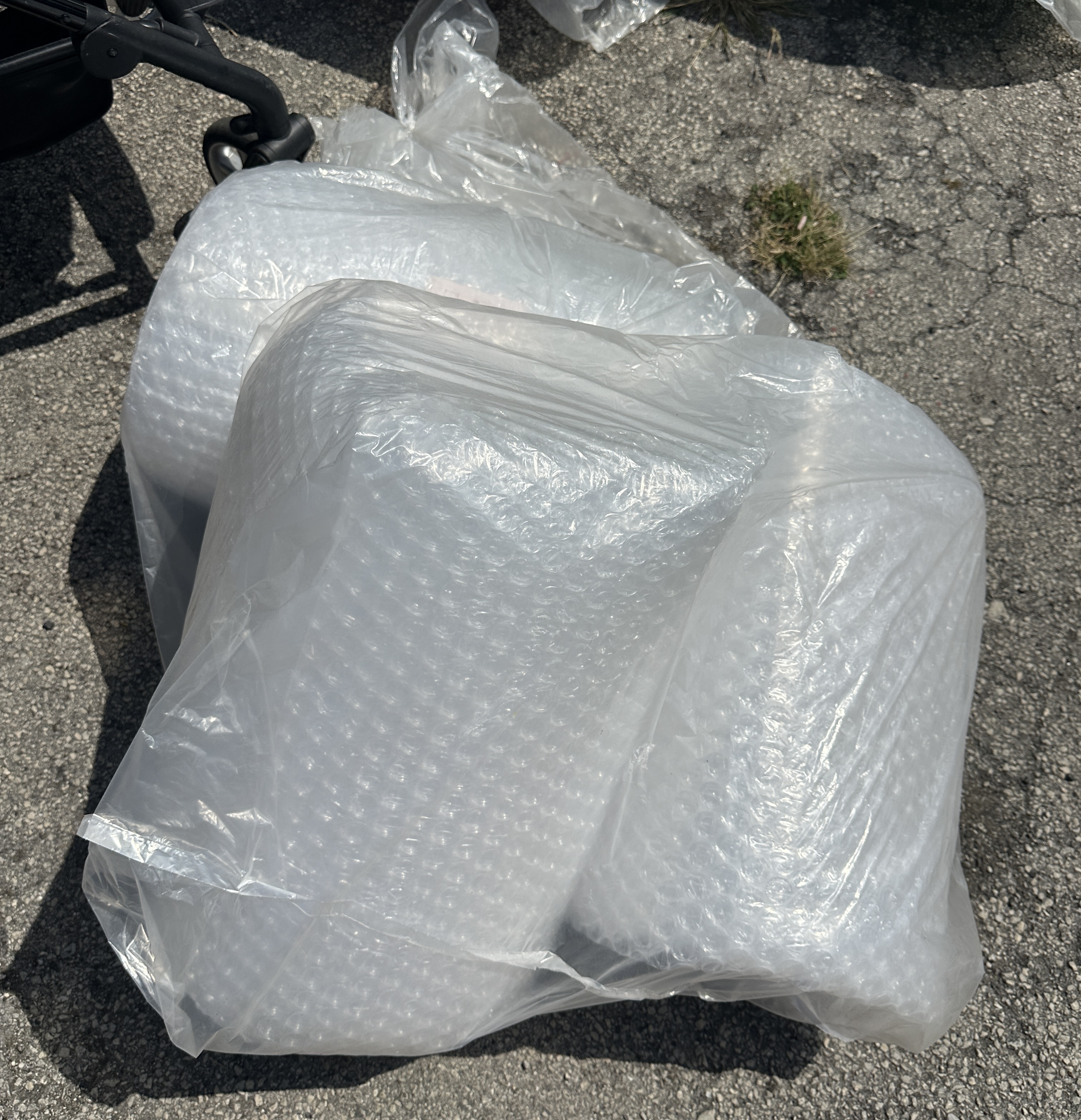 An Assortment of Clear Plastic Bubble Wrap Cushioning Rolls in a Transport Bag